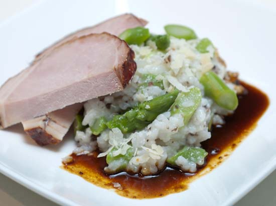 Risotto met groene asperges en truffeltapenade waarbij gegaard varkensribstuk en jus